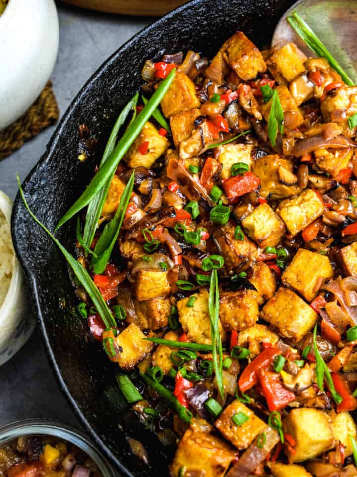 Tofu sisig feature in a pan. Rice and ensaladang talong on the side.