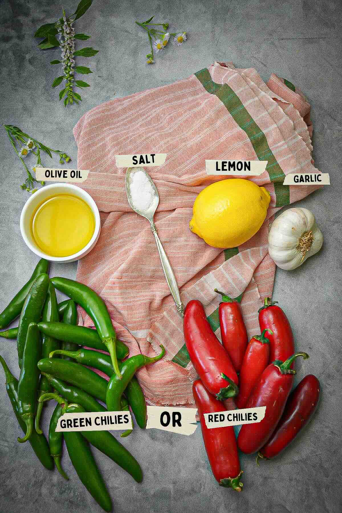 shatta sauce ingredients measured and labeled on a pink cloth on a table with flowers.