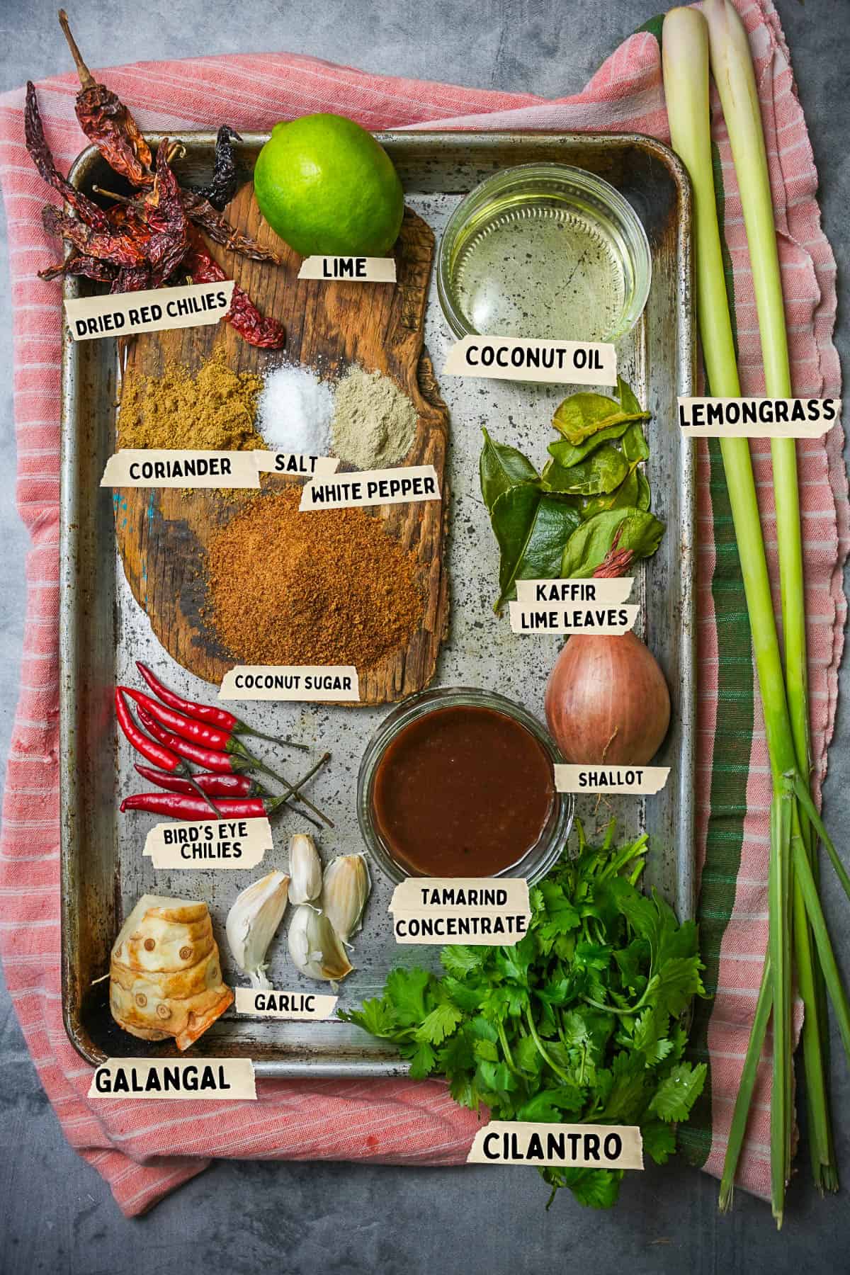Ingredients measured out and labeled for tom yum paste on a metal tray.