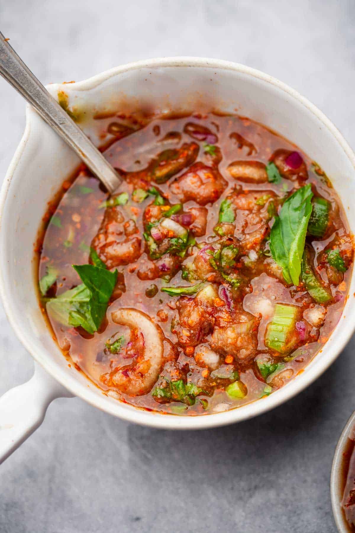 A bowl of nam jim jeaw with a spoon in it.